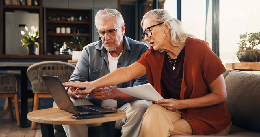 Elderly couple reviewing retirement budgets